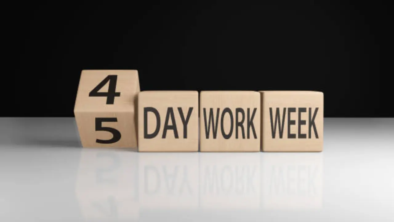 Studio image of four wooden blocks depicting the introduction of a four day week.