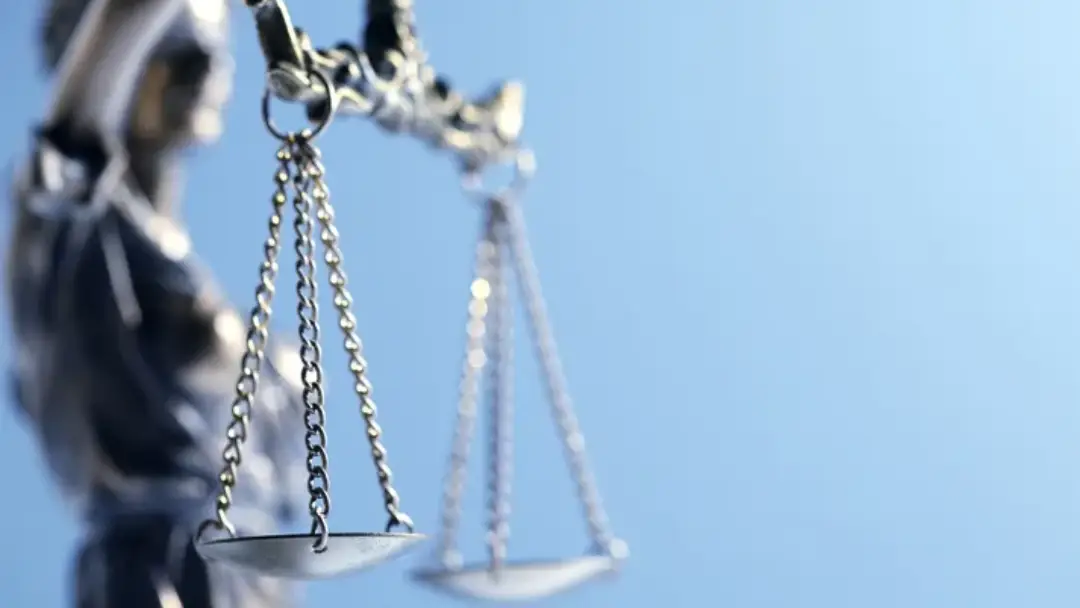 Image of a set of old scales often used as a symbol for justice.
