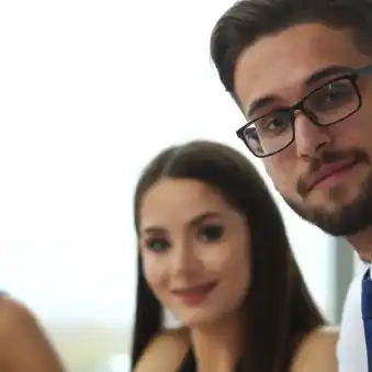 Close-up image of persons in an office looking like HR consultants offering a service